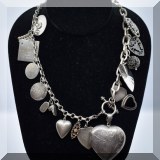 J059. Silver charms necklace. Most charms marked sterling. 24” - $85